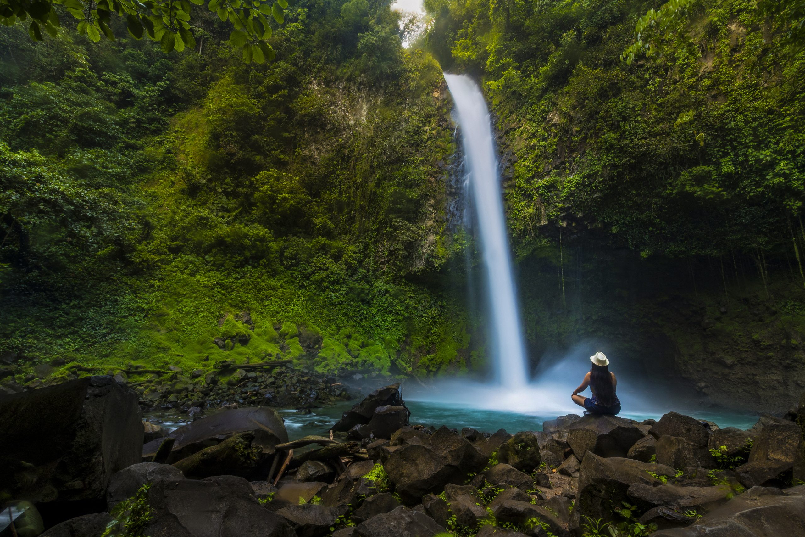 Costa Rica La Fortuna waterfall lady on rocks