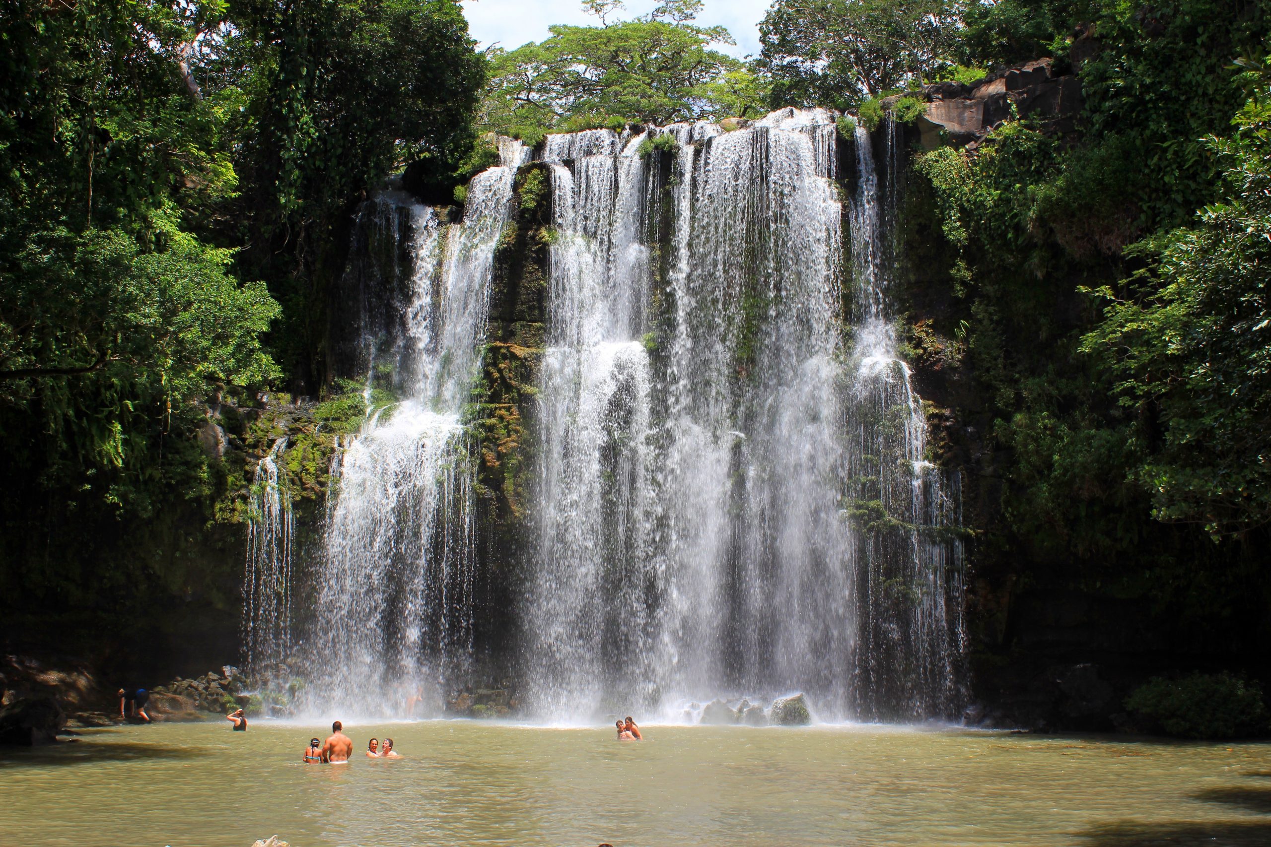 Costa Rica Llano de Cortes waterfall and swimmers