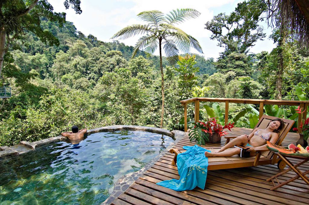 Couple enjoy their private romantic pool at Pacuare Lodge